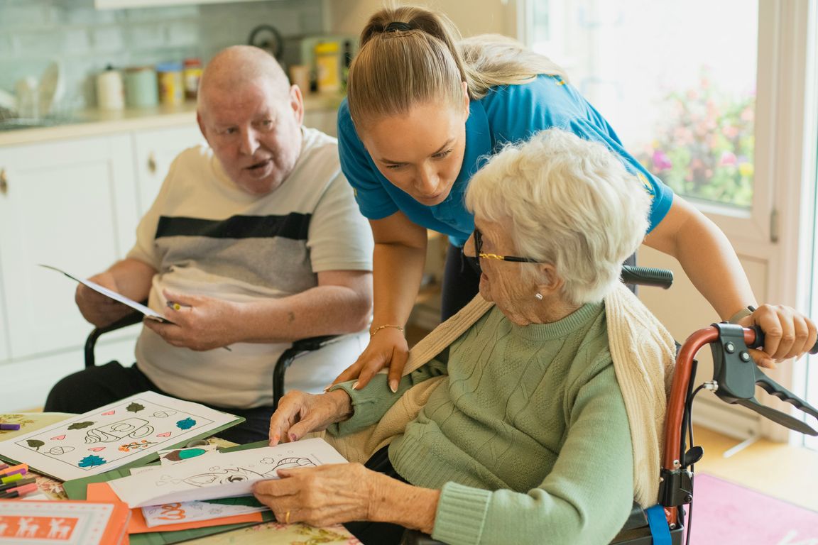 Compassionate caregiver supporting an elderly person at home in Annandale with cup of tea